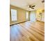 Bedroom featuring light wood flooring, windows for natural light, and a connecting bathroom at 10320 White Cedar St, Port Richey, FL 34668