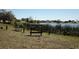 A tranquil view of the Palm Lake area, complete with signage and lakeside benches at 10320 White Cedar St, Port Richey, FL 34668