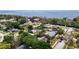 Aerial view of houses, greenery, and a beautiful bay, highlighting the neighborhood's appeal at 1037 Jamaica Way, Tarpon Springs, FL 34689