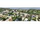Wide aerial view captures a neighborhood with waterfront homes and dense tree coverage at 1037 Jamaica Way, Tarpon Springs, FL 34689