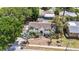 Aerial view of a single-Gathering home showcasing landscaping, roof, and neighborhood at 1037 Jamaica Way, Tarpon Springs, FL 34689