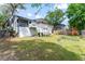 Landscaped backyard features a deck, garden, and playset, perfect for outdoor activities and relaxation at 1037 Jamaica Way, Tarpon Springs, FL 34689