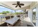 Inviting covered deck with outdoor dining set, ceiling fan, perfect for relaxing and entertaining at 1037 Jamaica Way, Tarpon Springs, FL 34689