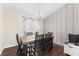 Bright dining room with wood table, seating for six, decorative chandelier, and neutral walls at 1037 Jamaica Way, Tarpon Springs, FL 34689