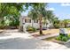 View of the driveway and landscaped front yard with vibrant plants, offering curb appeal at 1037 Jamaica Way, Tarpon Springs, FL 34689