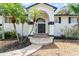 Inviting front entrance with double doors, an arched entryway and manicured landscaping at 1037 Jamaica Way, Tarpon Springs, FL 34689