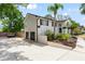 Side exterior view showing a garage and driveway, enhanced by landscaping at 1037 Jamaica Way, Tarpon Springs, FL 34689