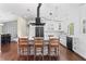 Modern kitchen with island and barstools, white cabinetry, and stainless-steel appliances at 1037 Jamaica Way, Tarpon Springs, FL 34689