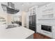 Modern kitchen with white cabinetry, stainless steel appliances and hardwood floors connects to dining room at 1037 Jamaica Way, Tarpon Springs, FL 34689