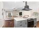 Open concept living space with kitchen island, living room, and dining room at 1037 Jamaica Way, Tarpon Springs, FL 34689