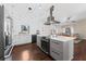 Modern kitchen features stainless steel appliances, island, and sleek countertops, with a view to the living room at 1037 Jamaica Way, Tarpon Springs, FL 34689