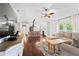 Open-concept living space with kitchen, living room, hardwood floors, and natural light at 1037 Jamaica Way, Tarpon Springs, FL 34689