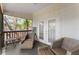 Comfortable screened-in porch featuring outdoor seating, providing a peaceful spot for relaxation and fresh air at 1037 Jamaica Way, Tarpon Springs, FL 34689