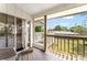 Enclosed porch with wicker furniture, and a view of backyard, offering a relaxing outdoor space at 1037 Jamaica Way, Tarpon Springs, FL 34689