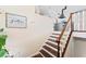 Staircase with wood stairs and white risers leads to kitchen with modern appliances and hood at 1037 Jamaica Way, Tarpon Springs, FL 34689