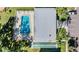 Aerial view of community pool and shuffleboard courts surrounded by lush landscaping at 11511 113Th St # 22E, Largo, FL 33778