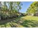 Lush green backyard with shade trees offers a serene outdoor retreat for relaxation and activities at 11511 113Th St # 22E, Largo, FL 33778