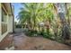 Charming backyard with tropical landscaping and mature trees, offering a private outdoor space at 11511 113Th St # 22E, Largo, FL 33778