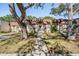 Charming home exterior with mature trees framing the entrance, sidewalk, and tidy landscaping at 11511 113Th St # 22E, Largo, FL 33778