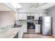 Bright kitchen with stainless steel appliances and updated countertops at 11511 113Th St # 22E, Largo, FL 33778