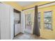 Laundry room with stackable washer and dryer, tile floor, and a door to the backyard at 11511 113Th St # 22E, Largo, FL 33778