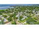 Aerial view of neighborhood near the ocean with trees and well-maintained yards; home marked with red arrow at 116 19Th Se Ave, St Petersburg, FL 33705