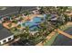 Aerial view of the community pool area with lounge chairs, lush landscaping, and lake access at 11707 Lilac Pearl Ln, Parrish, FL 34219