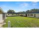 Expansive backyard with green grass, offering ample space for recreation and outdoor gatherings at 11719 Boynton Lane, New Port Richey, FL 34654