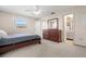 Bright bedroom with a queen bed, carpet flooring, and a large dresser for storage at 11719 Boynton Lane, New Port Richey, FL 34654