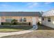 Charming single-story home featuring a metal roof, manicured lawn, and inviting walkway at 11719 Boynton Lane, New Port Richey, FL 34654