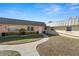 A cozy single-story home with a metal roof, pretty garden beds, and a convenient walkway at 11719 Boynton Lane, New Port Richey, FL 34654