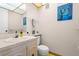 Well-maintained half bathroom features a white vanity and neutral wall decor at 11719 Boynton Lane, New Port Richey, FL 34654