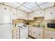 Efficient kitchen features white appliances, great storage, and a bright overhead light at 11719 Boynton Lane, New Port Richey, FL 34654