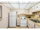 Functional kitchen equipped with white appliances, ample cabinet space, and a bright ceiling light at 11719 Boynton Lane, New Port Richey, FL 34654