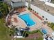 An aerial view of a community pool with chairs and a hot tub for resident relaxation and recreation at 11719 Boynton Lane, New Port Richey, FL 34654