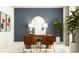 A home office with neutral colors, decorative art, and modern desk at 11861 Sparkling Topaz Cv, Parrish, FL 34219
