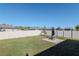 Spacious backyard featuring a well-maintained lawn and a patio area with a fire pit at 12103 Gothic Rd, Spring Hill, FL 34610
