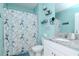 Charming bathroom with a dog-themed shower curtain and decorative shelving at 12103 Gothic Rd, Spring Hill, FL 34610