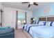 Comfortable bedroom featuring a ceiling fan, and a neatly made bed at 12103 Gothic Rd, Spring Hill, FL 34610