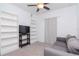 Bedroom with a gray couch, television, and ample bookshelf space at 12103 Gothic Rd, Spring Hill, FL 34610