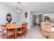 Dining room with rustic light fixture, wood table, and view into entrance at 12103 Gothic Rd, Spring Hill, FL 34610