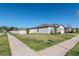 Exterior view of the home showing the well-maintained lawn and its location on a corner lot at 12103 Gothic Rd, Spring Hill, FL 34610