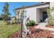Landscaped front yard featuring a unique metal lizard sculpture and decorative mulch at 12103 Gothic Rd, Spring Hill, FL 34610