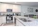 Open-concept kitchen featuring stainless steel appliances, granite counters, and island with sink at 12103 Gothic Rd, Spring Hill, FL 34610