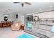 Spacious living room featuring a ceiling fan and an open layout leading to the kitchen at 12103 Gothic Rd, Spring Hill, FL 34610