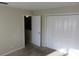 Bedroom featuring double doors to the closet, neutral carpet and view of the staircase at 12611 Touchton Dr # 122, Tampa, FL 33617