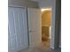 Bedroom featuring double doors to the closet, neutral carpet and view of the staircase at 12611 Touchton Dr # 122, Tampa, FL 33617