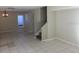 Spacious living room featuring tile flooring, neutral walls, and a staircase leading to the second floor at 12611 Touchton Dr # 122, Tampa, FL 33617