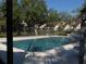 Large community pool surrounded by a concrete deck and mature trees at 12611 Touchton Dr # 122, Tampa, FL 33617