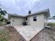 A view of the backyard with a small patio and well-maintained lawn at 1312 Tuscola St, Clearwater, FL 33756